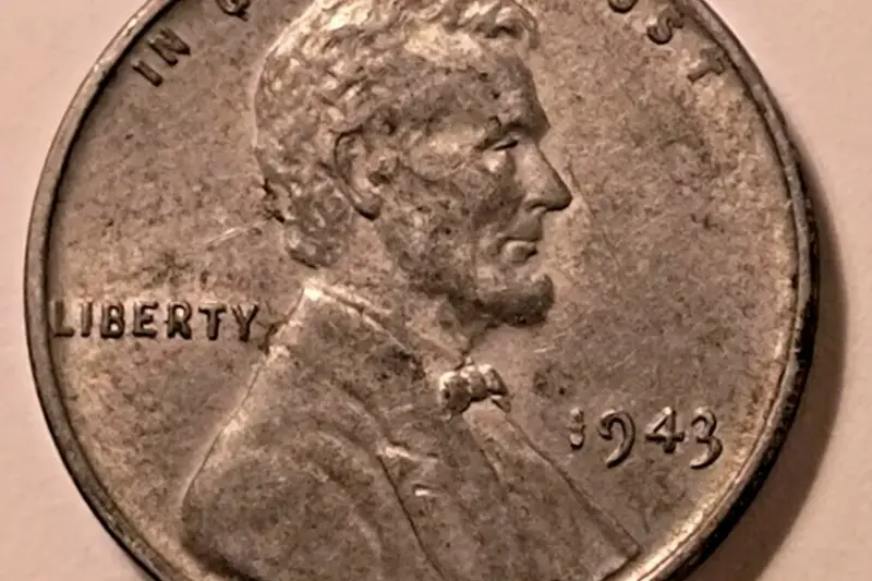 A 1943 steel Lincoln cent beside wartime coinage