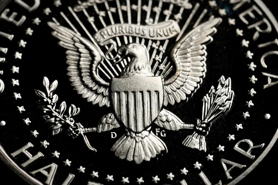 1964-D Kennedy half dollar reverse showing the heraldic eagle; the D mint mark sits left of the eagle's tail feathers